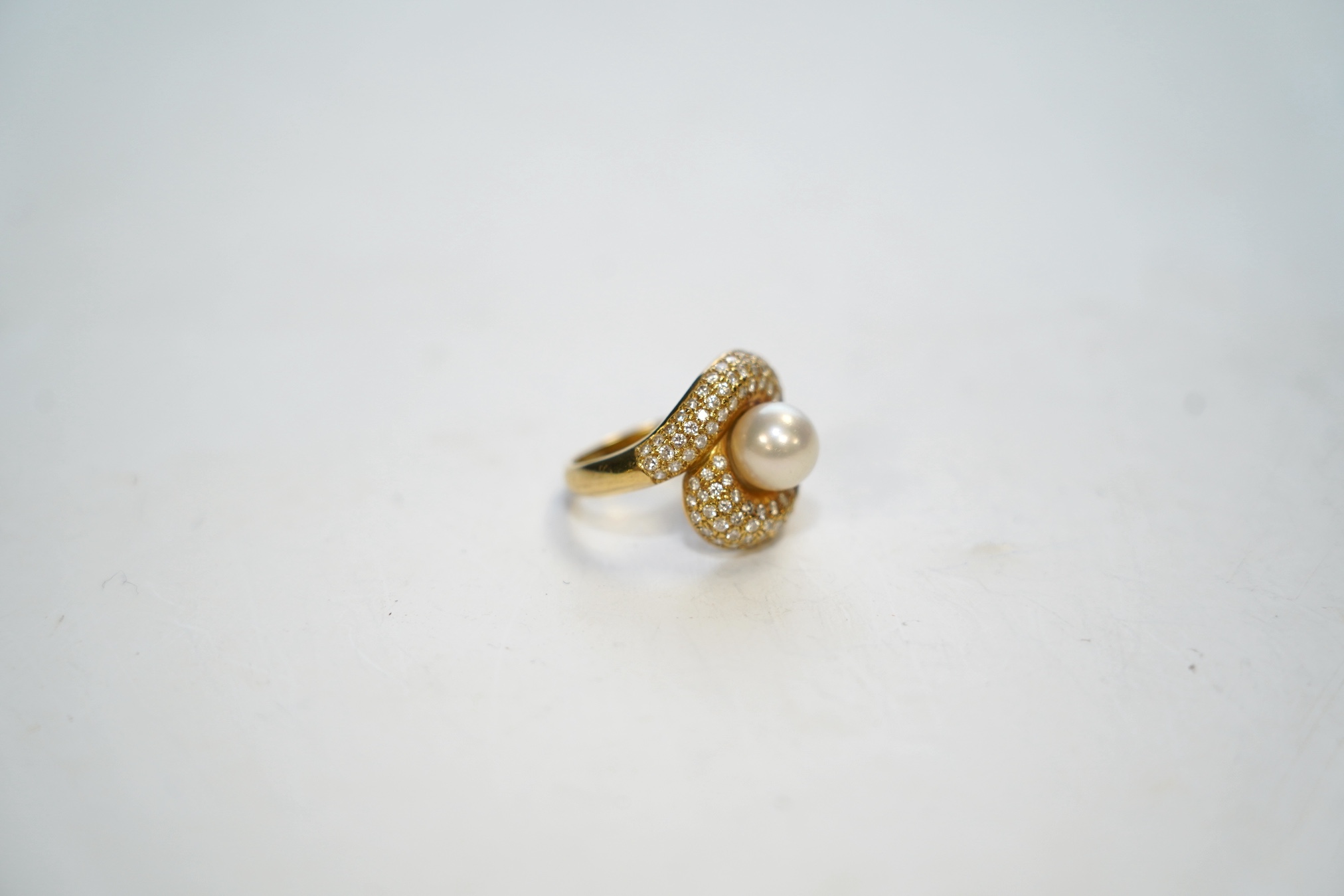 A modern 18ct gold, single stone cultured pearl and diamond chip cluster set dress ring, size M, gross weight 7.5 grams. Condition - good